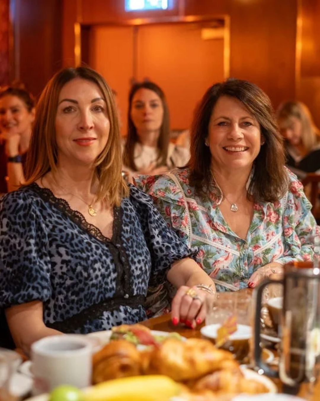 Two guests at a table with breakfast pastries