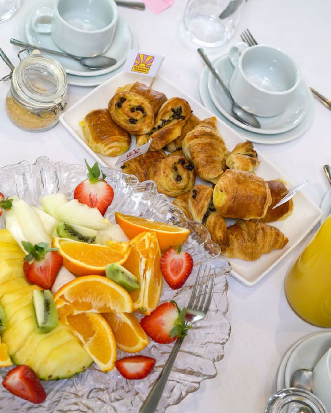 Breakfast pastries and a platter of fresh fruit